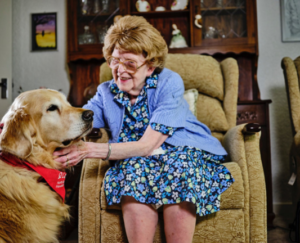 An elderly lady with a Wag and Company dog